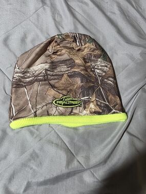 Team Realtree camo youth beanie with a bright green band and heat retention tech